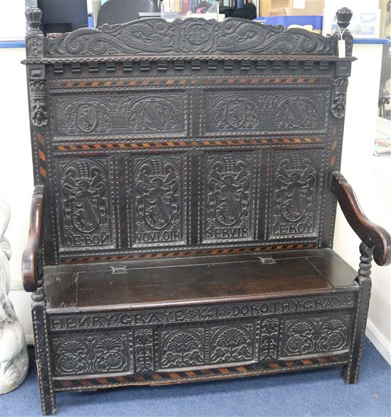A 17th century style inlaid oak monks bench, W.4ft 4in. D.1ft 11in. H.5ft